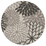 Nourison - Nourison Aloha 7'10" Round Silver Grey Tropical Area Rug - In shades of multi-toned grey, this Aloha indoor/outdoor rug brings extra life and excitement to your patio, deck, or poolside. Its high-low construction combines delightful texture with an intricately woven base for an exceptional look and feel that stands up to the elements. Machine made from premium stain-resistant fibers for long wear and easy cleaning: just rinse with a hose and air dry.