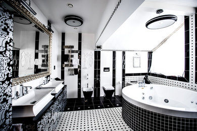 This is an example of a contemporary master bathroom in Moscow with a hot tub and black and white tile.