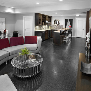 This is an example of a classic fully buried basement in Edmonton with grey walls, no fireplace and black floors.