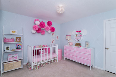 Mid-sized traditional nursery in Dallas with blue walls and carpet for girls.