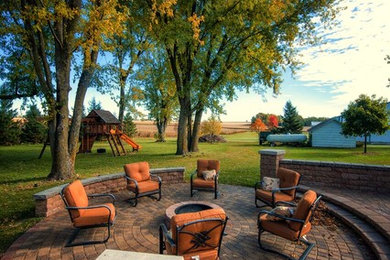 Patio - huge craftsman backyard concrete paver patio idea in Other with a fire pit and no cover
