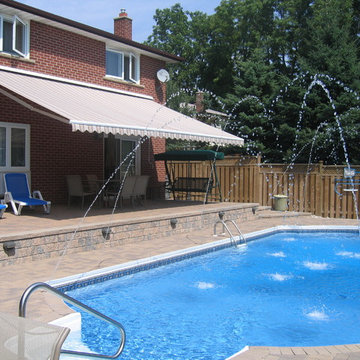 Retractable awning over patio by the pool