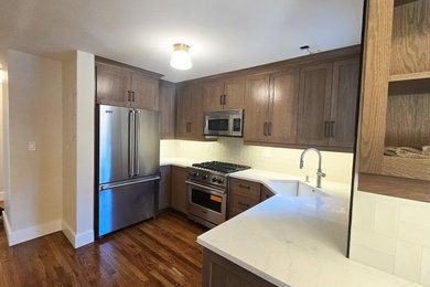 Eat-in kitchen - mid-sized contemporary galley dark wood floor, brown floor and coffered ceiling eat-in kitchen idea in New York with an undermount sink, shaker cabinets, gray cabinets, quartzite countertops, white backsplash, ceramic backsplash, stainless steel appliances, an island and white countertops
