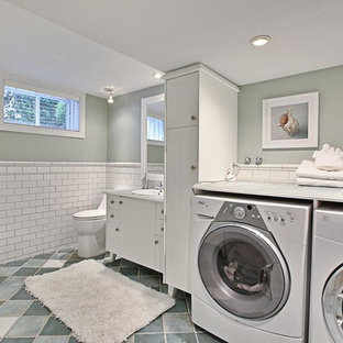 This is an example of a medium sized l-shaped utility room in Montreal with a built-in sink, flat-panel cabinets, white cabinets, tile countertops, terracotta flooring, a side by side washer and dryer and grey walls.