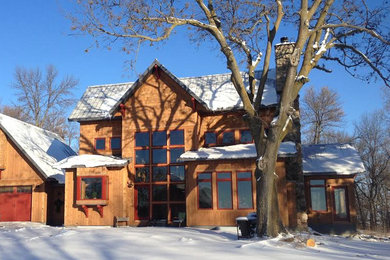 Mid-sized rustic brown two-story wood exterior home idea in Other with a metal roof
