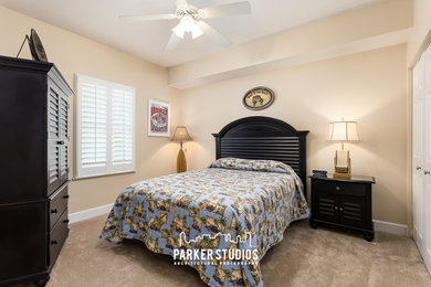 Example of a small island style guest carpeted bedroom design in Orlando with beige walls and no fireplace
