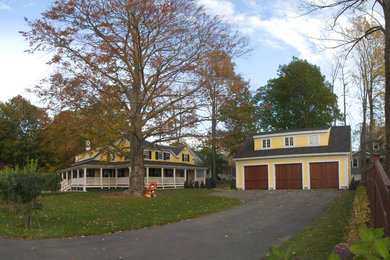 Example of a large yellow two-story wood exterior home design in Portland Maine