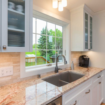Modern Kitchen with White Flat Panel Shaker Cabinets & Natural Stone Backsplash