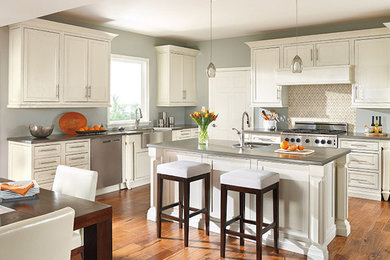 Mid-sized transitional l-shaped dark wood floor and brown floor eat-in kitchen photo in Orange County with an undermount sink, recessed-panel cabinets, white cabinets, concrete countertops, multicolored backsplash, cement tile backsplash, stainless steel appliances and an island