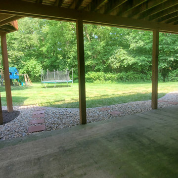 Brick line creation with decorative rock, French drain & rubber mulch placement.