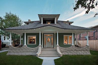 Inspiration for a timeless green two-story wood house exterior remodel in Houston with a hip roof and a shingle roof