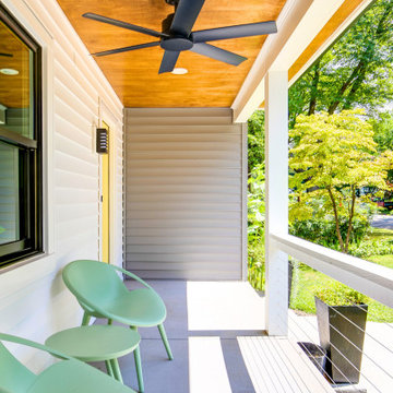 Inviting Front Porch with Wood Ceiling and Cable Railing