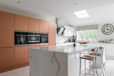 Inspiration for a large contemporary grey and white l-shaped open plan kitchen in Other with a double-bowl sink, granite worktops, white splashback, granite splashback, integrated appliances, ceramic flooring, an island, beige floors, white worktops, a drop ceiling and feature lighting.