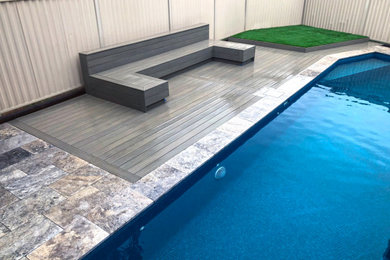 This is an example of a mid-sized modern backyard pool in Sydney with decking.