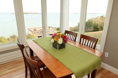 Great room - small transitional medium tone wood floor great room idea in Portland Maine with beige walls and no fireplace