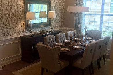 Enclosed dining room - transitional medium tone wood floor enclosed dining room idea in Boston with multicolored walls and no fireplace