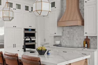 Large transitional u-shaped light wood floor and brown floor eat-in kitchen photo in Orlando with a drop-in sink, beaded inset cabinets, white cabinets, quartz countertops, multicolored backsplash, mosaic tile backsplash, stainless steel appliances, an island and white countertops