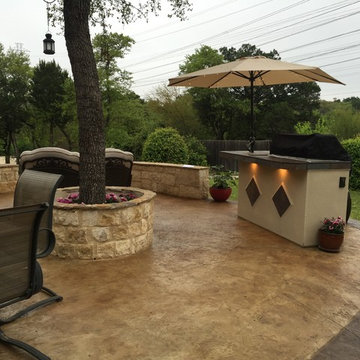 Stamped and Stained Decorative Concrete Patio with Limestone Retaining Wall
