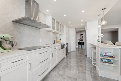 Example of a mid-sized trendy galley porcelain tile and gray floor kitchen pantry design in Ottawa with a farmhouse sink, shaker cabinets, white cabinets, quartzite countertops, white backsplash, ceramic backsplash, stainless steel appliances, a peninsula and white countertops