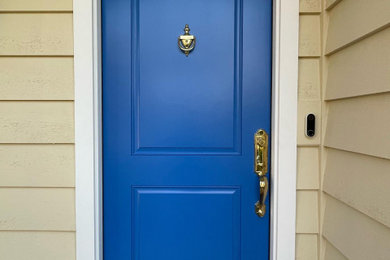 Entryway - small transitional entryway idea with a blue front door
