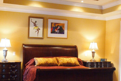 Inspiration for a large transitional master dark wood floor bedroom remodel in Other with yellow walls and no fireplace