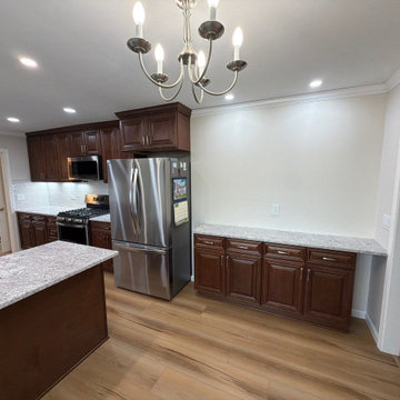 USCD cabinetry accompanied granite countertops, porcelain tile backsplash and Ca