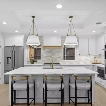 White Kitchen with Double Ovens and Island Seating