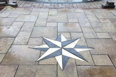 Inspiration for a mid-sized partial sun backyard concrete paver landscaping in Other with a fire pit.