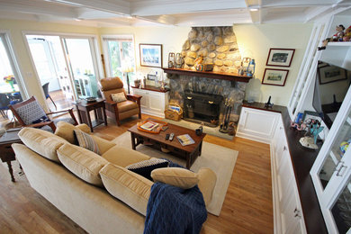 Living room - mid-sized traditional open concept medium tone wood floor living room idea in New York with yellow walls, a standard fireplace, a stone fireplace and a media wall
