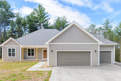 Example of a transitional attached three-car garage design in Charlotte