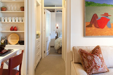 Small transitional dark wood floor hallway photo in New York with beige walls