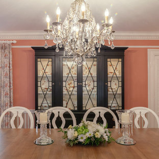 Diseño de comedor romántico, grande, cerrado, sin chimenea, con paredes rosas y suelo de madera oscura