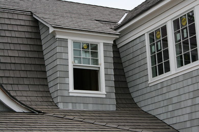 Example of a large classic gray two-story wood exterior home design in New York