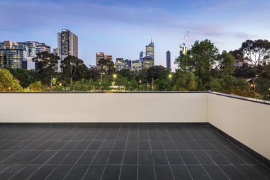 This is an example of a modern backyard patio in Melbourne with no cover.