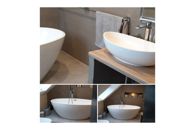 Photo of a small ensuite bathroom in Hanover with flat-panel cabinets, a freestanding bath, a two-piece toilet, grey walls, cement flooring, a vessel sink, concrete worktops, grey floors, beige worktops, an enclosed toilet, a single sink and a built in vanity unit.