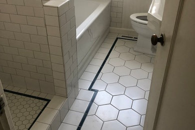 Photo of a small bathroom in San Francisco with a built-in bath, white tiles, ceramic tiles, ceramic flooring and white floors.