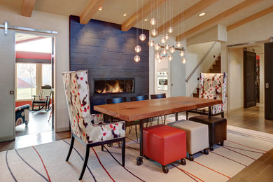 Mid-sized transitional light wood floor and brown floor great room photo in Cleveland with beige walls, a ribbon fireplace and a stone fireplace