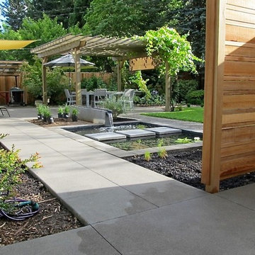 Project #1 AFTER: New water feature with rill and pond steps opens up the space