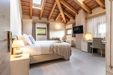 Inspiration for a contemporary master bedroom in Bologna with white walls, no fireplace and beige floor.