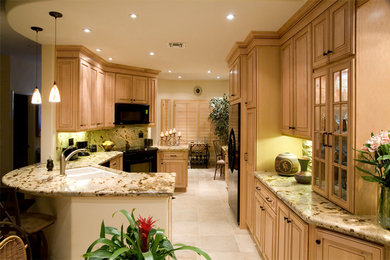 Eat-in kitchen - large traditional u-shaped white floor eat-in kitchen idea in Other with a double-bowl sink, raised-panel cabinets, light wood cabinets, multicolored backsplash, black appliances and no island