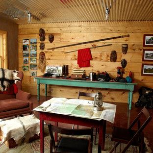 Medium sized rural walk-out basement in Minneapolis with brown walls, concrete flooring and red floors.