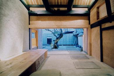 Photo of a mid-sized midcentury front yard patio in Other with natural stone pavers and a roof extension.