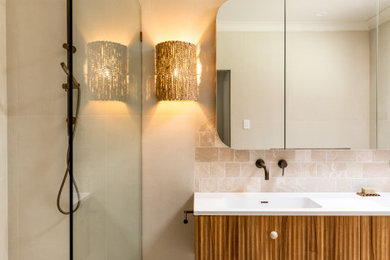 Photo of a mid-sized country bathroom in Newcastle - Maitland with brown cabinets, beige tile, porcelain tile, white benchtops, a double vanity and a floating vanity.