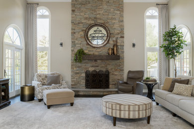 Example of a huge transitional open concept dark wood floor, brown floor and tray ceiling family room design in Philadelphia with beige walls, a standard fireplace, a stone fireplace and a wall-mounted tv