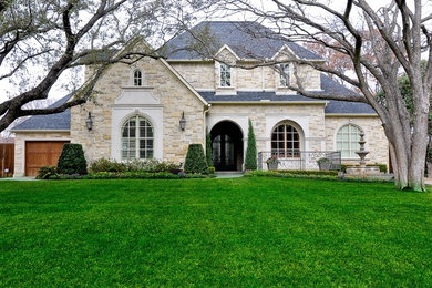 Inspiration for a huge timeless one-story stone exterior home remodel in Dallas