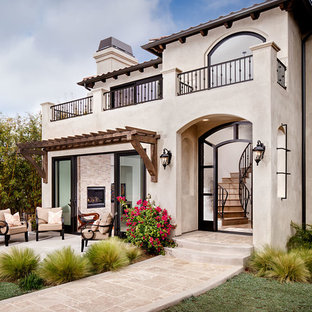 Inspiration for an expansive mediterranean stucco beige exterior in San Diego.
