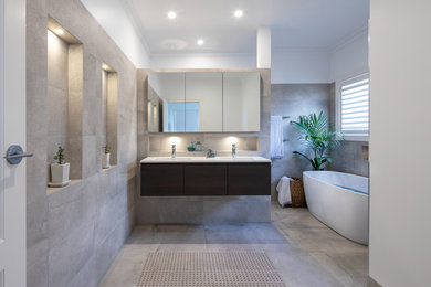 Large contemporary 3/4 bathroom in Melbourne with flat-panel cabinets, dark wood cabinets, a freestanding tub, an open shower, gray tile, porcelain tile, grey walls, porcelain floors, an undermount sink, engineered quartz benchtops, grey floor, an open shower and white benchtops.