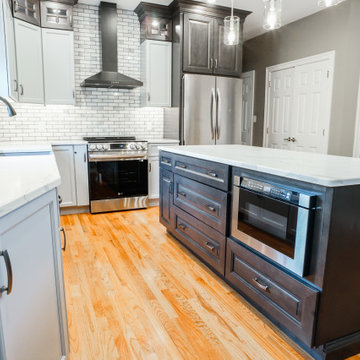 Multi-Tone Grey Cabinets w/ Island & Hardwood Floors