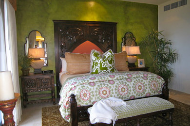 Example of a large tuscan master travertine floor bedroom design in Mexico City with green walls and no fireplace