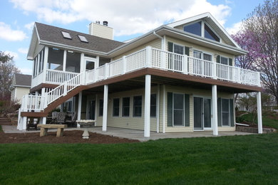 Example of a large classic backyard deck design in Omaha with no cover